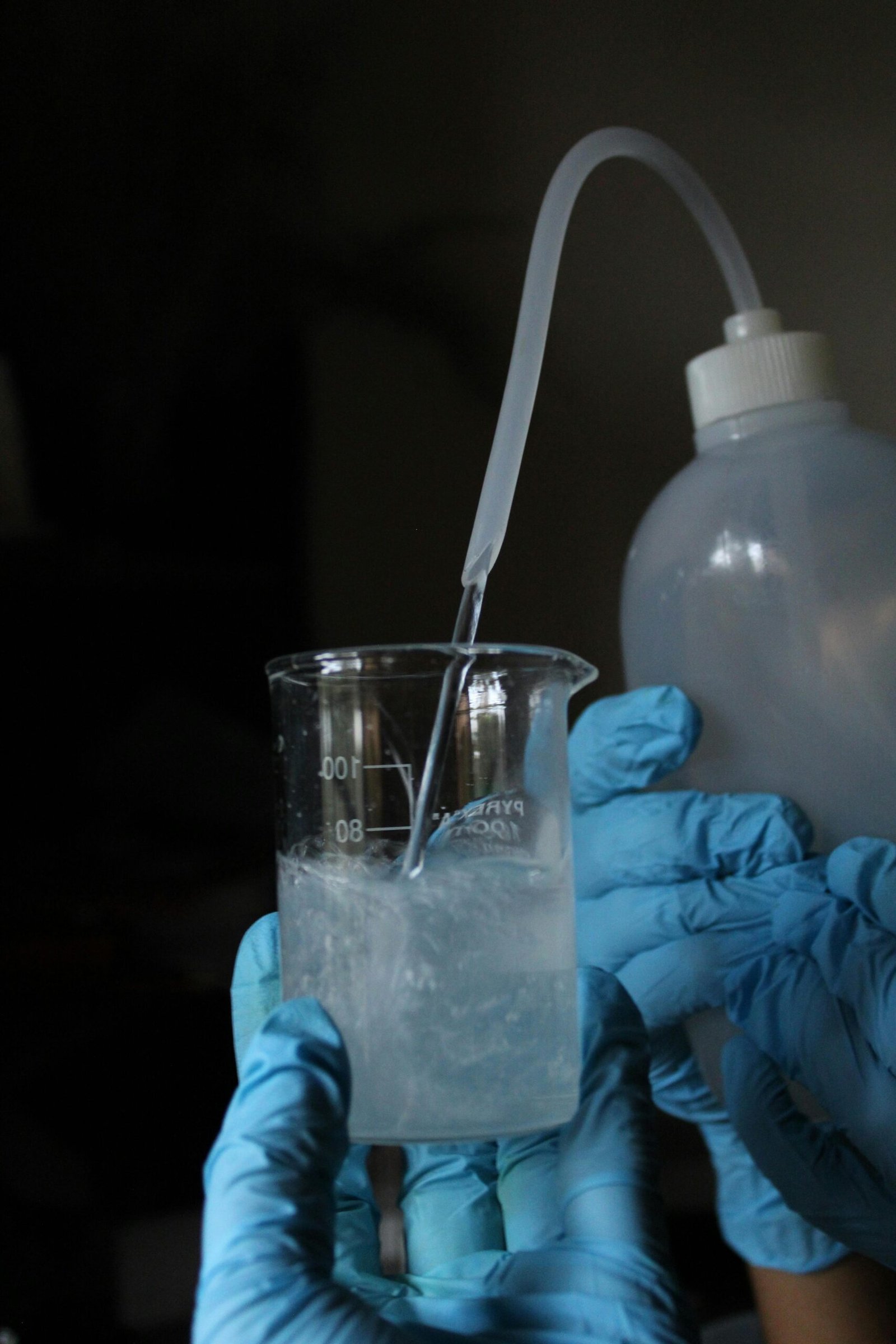 Scientist pouring liquid in a laboratory beaker